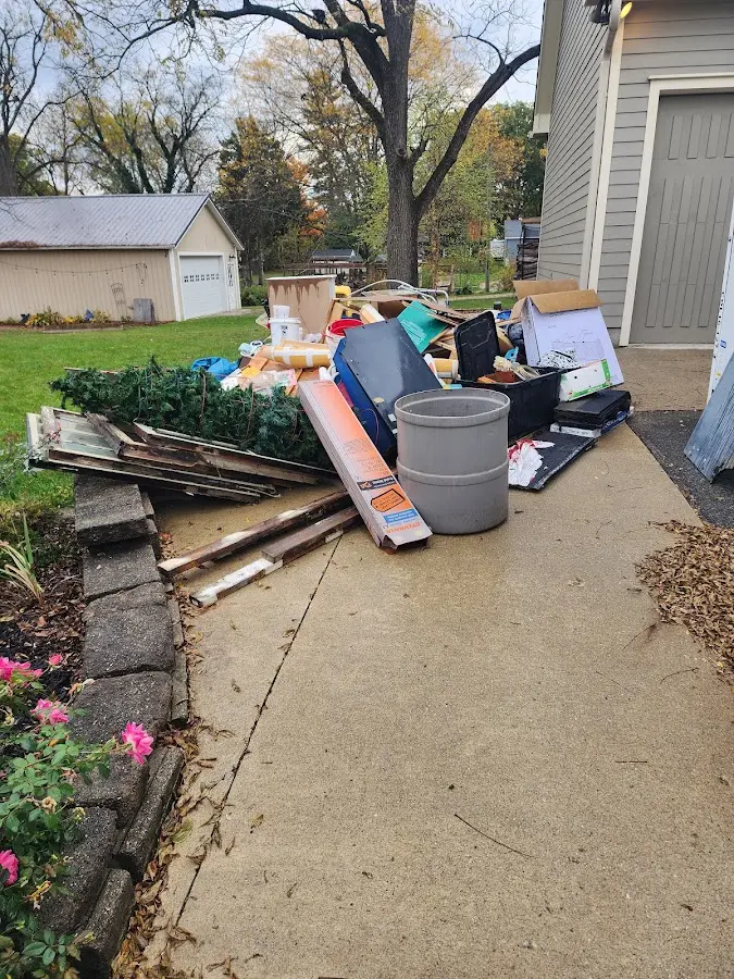 Dumpster being loaded with debris for 3 Yard Dumpster Rental in Muskegon Heights
